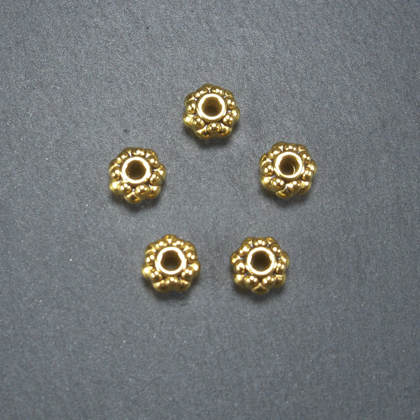 10 Spacer Perlen 7 mm, Blüten, goldfarben, 10465