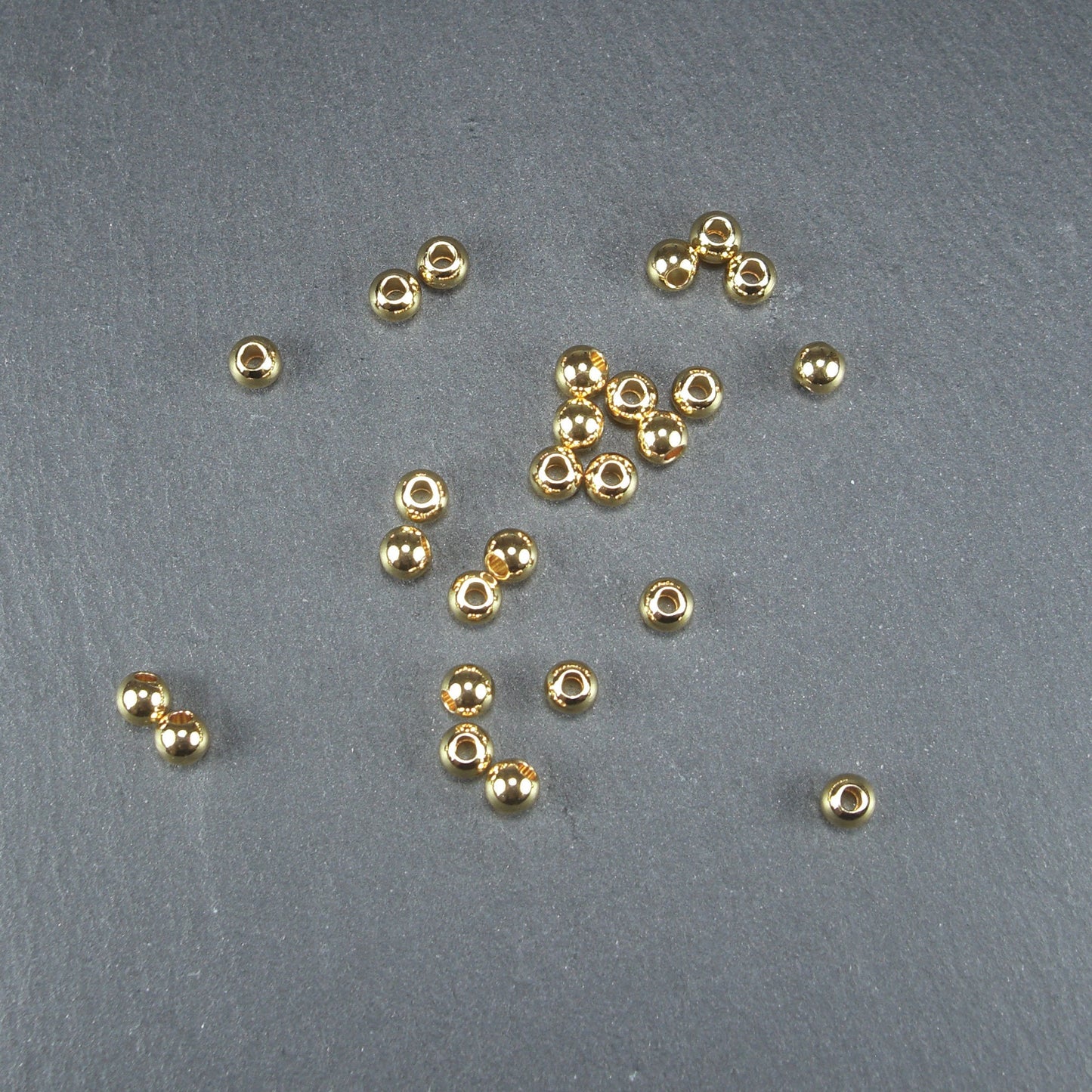 5 kleine runde Edelstahl Perlen 4 mm, goldfarben, 10634